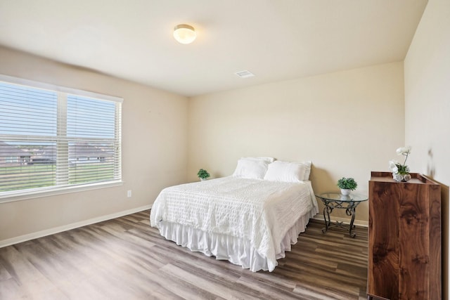 bedroom with hardwood / wood-style floors