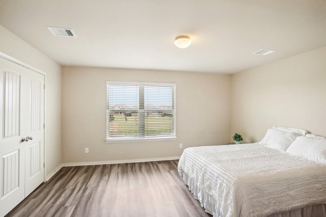 bedroom with a closet and wood-type flooring