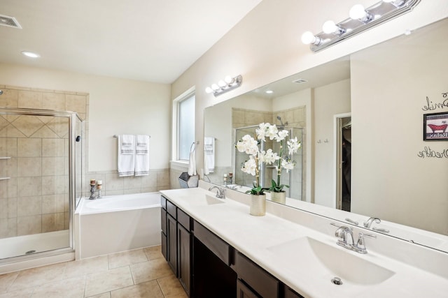 bathroom with shower with separate bathtub, vanity, and tile patterned floors