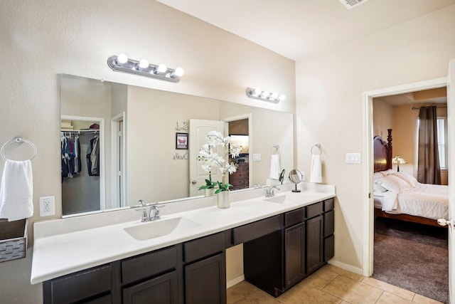 bathroom with tile patterned flooring and vanity