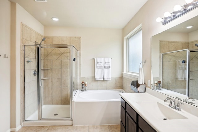 bathroom with tile patterned flooring, vanity, and separate shower and tub