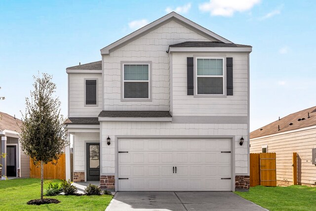 view of front property with a front yard and a garage