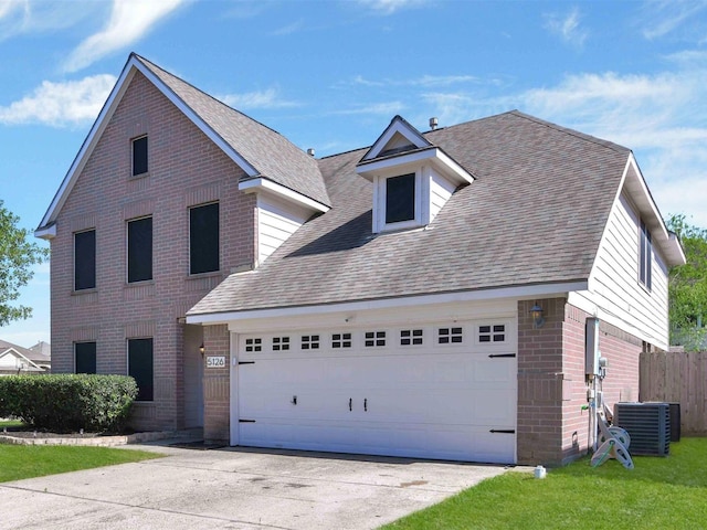 view of front of property with a garage and central AC