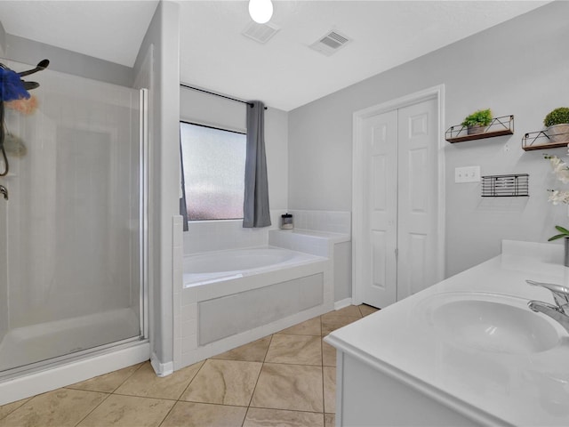 bathroom with tile patterned flooring, vanity, and independent shower and bath