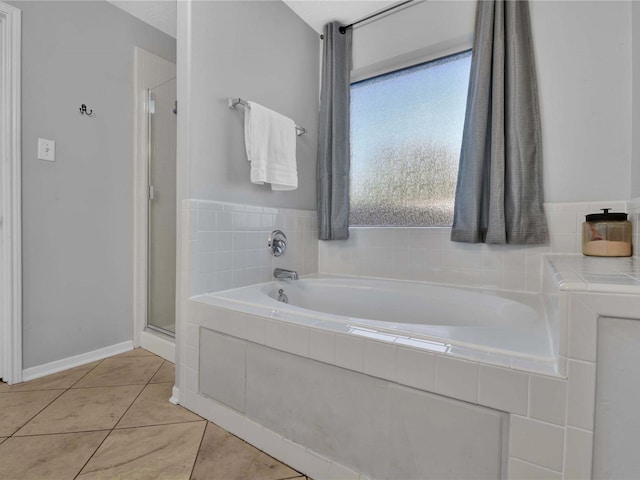 bathroom featuring tile patterned flooring and separate shower and tub