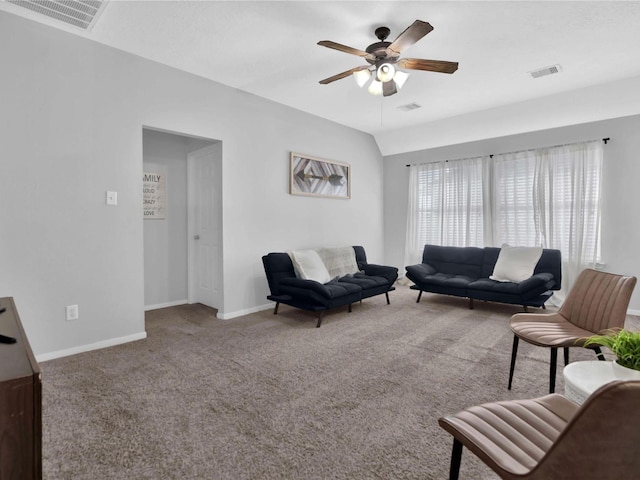 carpeted living room with ceiling fan and vaulted ceiling