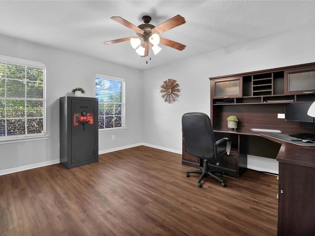 office featuring a textured ceiling, ceiling fan, and dark wood-type flooring