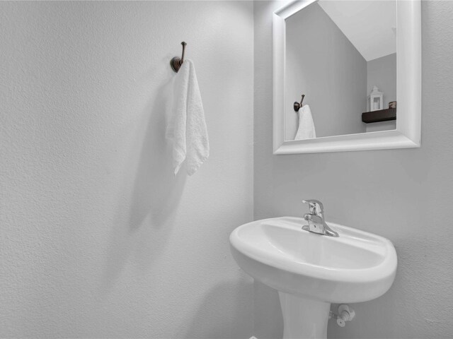 bathroom with sink and vaulted ceiling