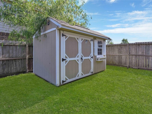 view of outbuilding with a yard