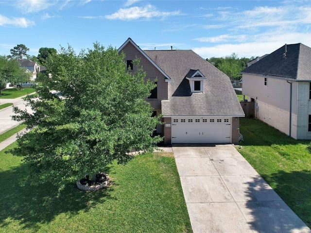 view of front of home featuring a garage and a front lawn