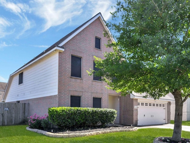 view of side of property featuring a yard and a garage