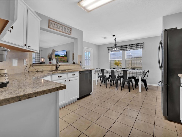 kitchen featuring light stone countertops, white cabinetry, pendant lighting, light tile patterned flooring, and black appliances