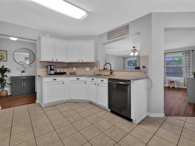 kitchen featuring dishwasher, light tile patterned floors, white cabinetry, and ceiling fan