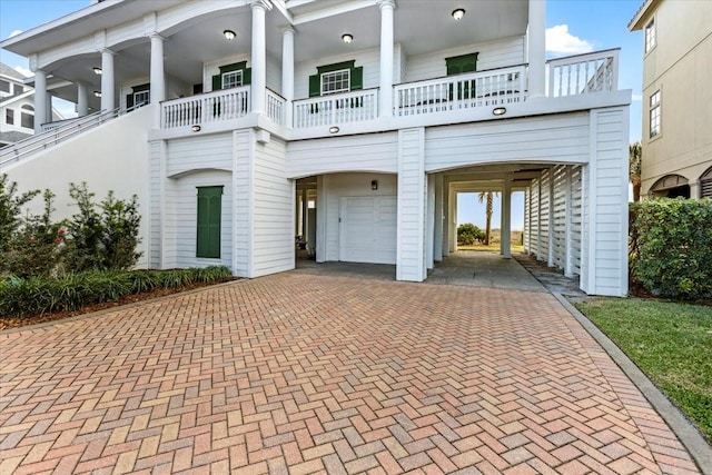 view of front of house with a carport and a garage