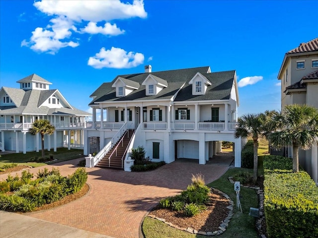 view of front facade with covered porch and a garage