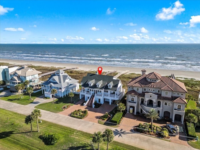 birds eye view of property with a water view and a view of the beach