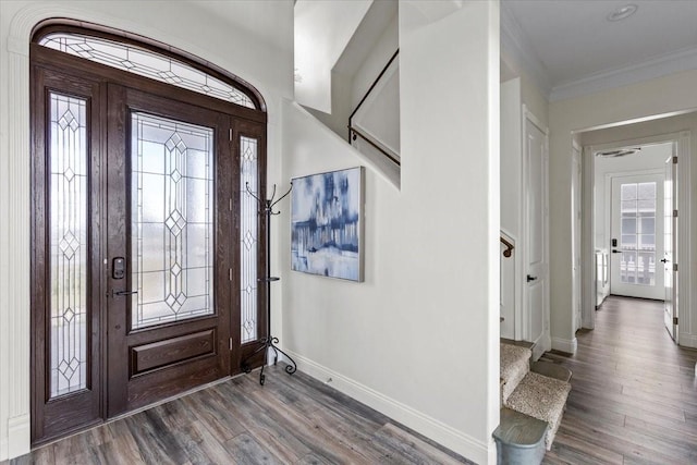 entrance foyer with hardwood / wood-style floors and ornamental molding