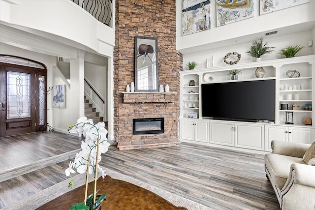 living room featuring a fireplace, hardwood / wood-style floors, and plenty of natural light