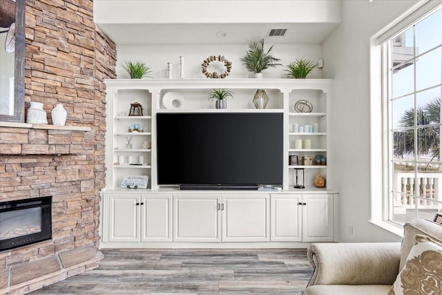 living room with a fireplace and light hardwood / wood-style flooring