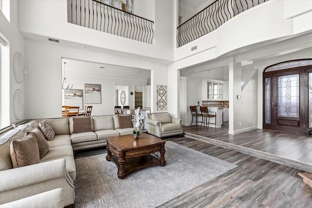 living room with a high ceiling and hardwood / wood-style flooring