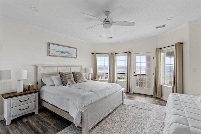 bedroom with multiple windows, dark hardwood / wood-style flooring, ceiling fan, and ornamental molding