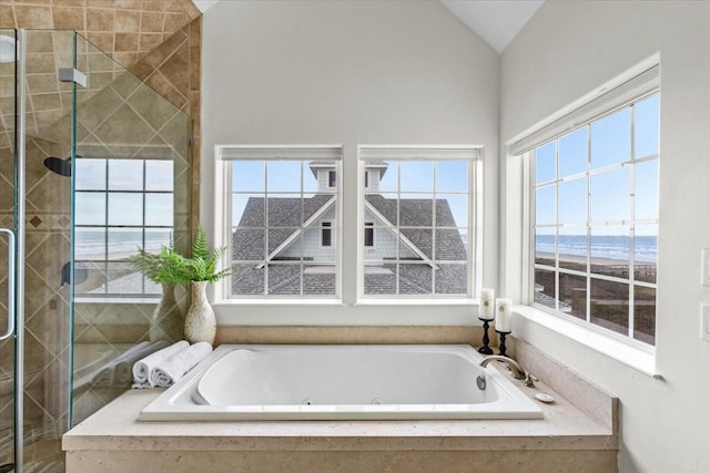 bathroom with a water view, lofted ceiling, and shower with separate bathtub