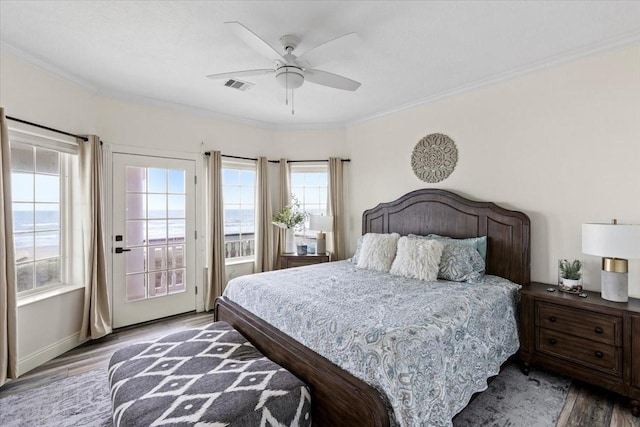 bedroom featuring ceiling fan, light hardwood / wood-style floors, and multiple windows