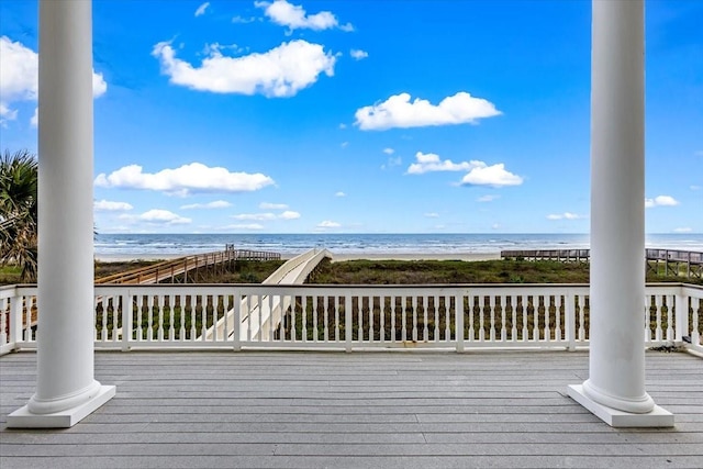 deck with a beach view and a water view