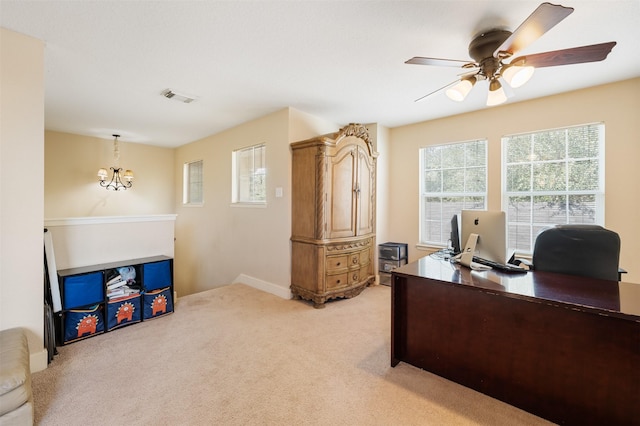 office space with ceiling fan with notable chandelier and light carpet