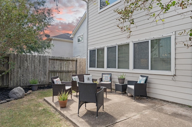 patio terrace at dusk featuring an outdoor hangout area