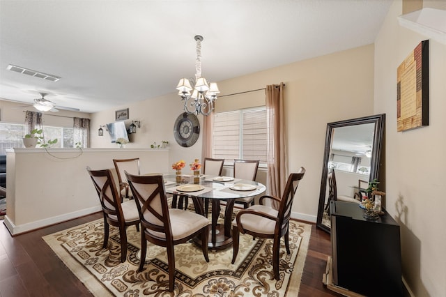 dining space featuring ceiling fan with notable chandelier and dark hardwood / wood-style floors