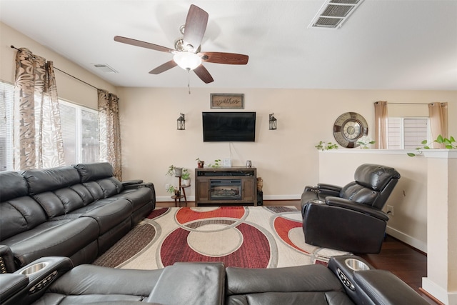 living room with ceiling fan and wood-type flooring