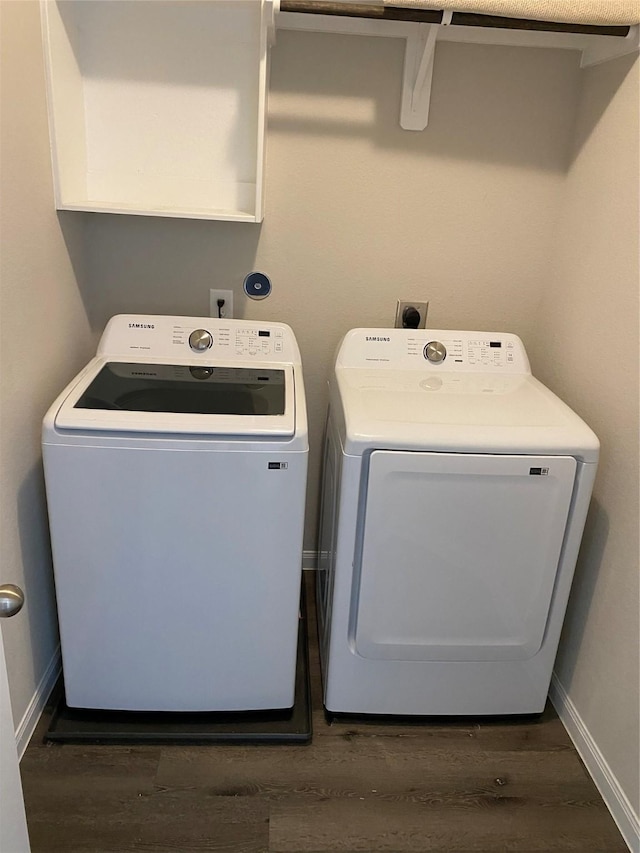 washroom featuring washer and clothes dryer and dark hardwood / wood-style floors