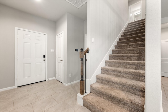 entryway with light tile patterned floors