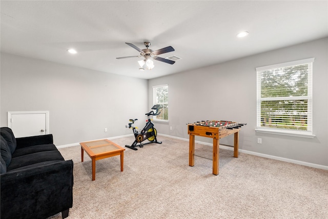 playroom with ceiling fan and light colored carpet