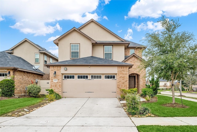 view of property featuring a front yard and a garage