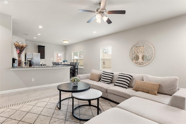 living room featuring ceiling fan and light tile patterned floors