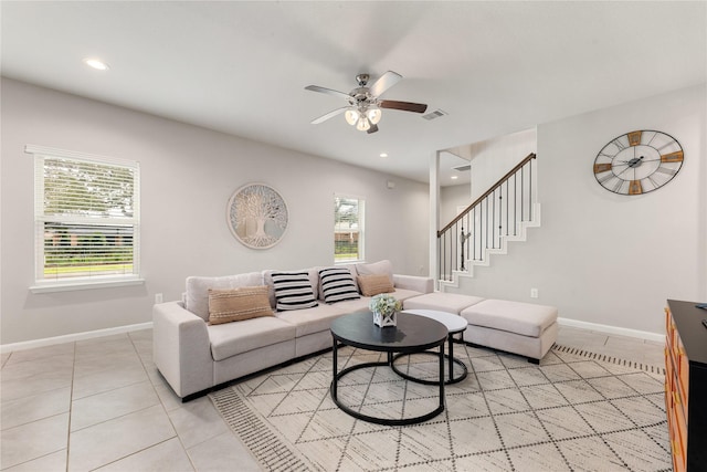 tiled living room featuring ceiling fan and a wealth of natural light