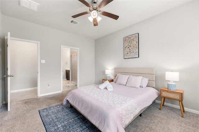 bedroom featuring ensuite bath, ceiling fan, and light carpet