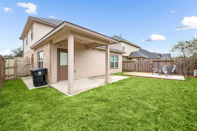 back of property with a patio area and a lawn