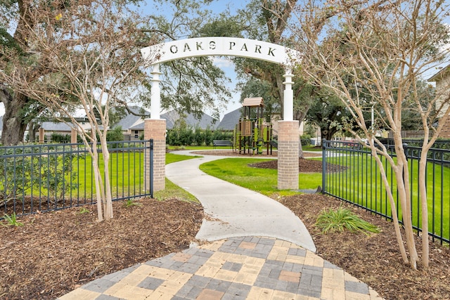 view of property's community featuring a yard and a playground