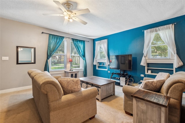 living room featuring light carpet, a textured ceiling, and ceiling fan