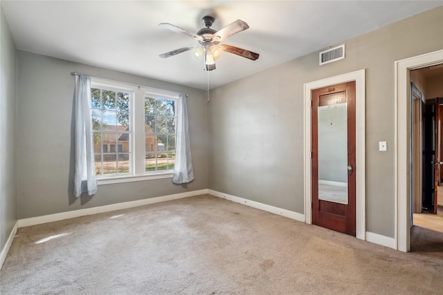 spare room with ceiling fan and carpet