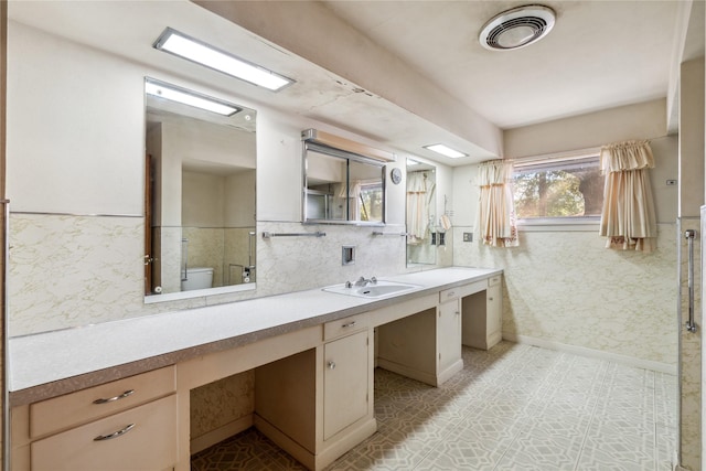 bathroom with vanity and toilet