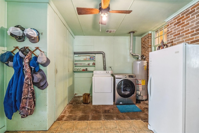 laundry room with washing machine and clothes dryer, ceiling fan, brick wall, and water heater