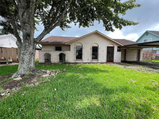 ranch-style home with a garage and a front lawn