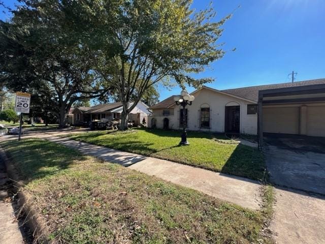 single story home featuring a garage and a front yard