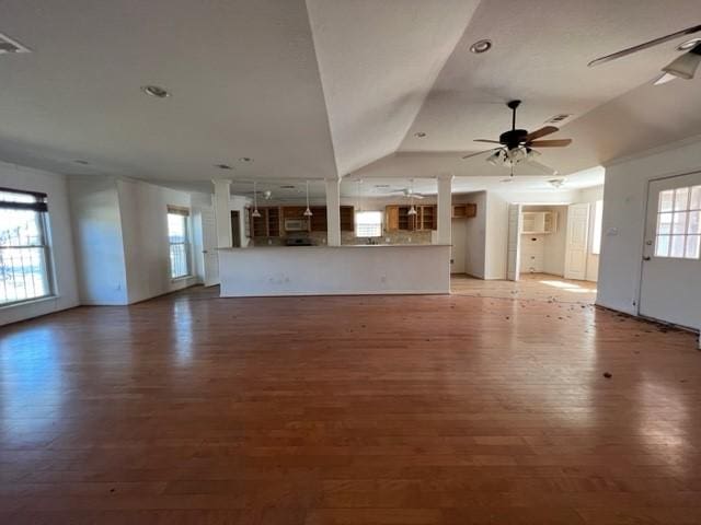 unfurnished living room featuring hardwood / wood-style flooring, ceiling fan, and lofted ceiling