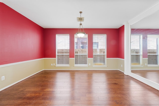 unfurnished dining area featuring hardwood / wood-style floors and a healthy amount of sunlight