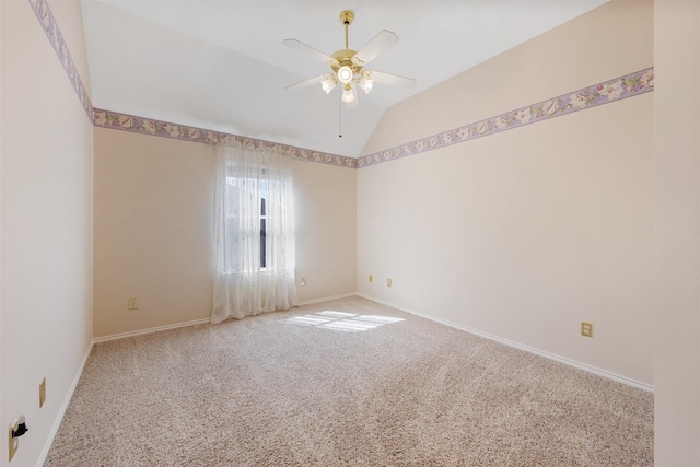 empty room featuring carpet flooring, ceiling fan, and vaulted ceiling